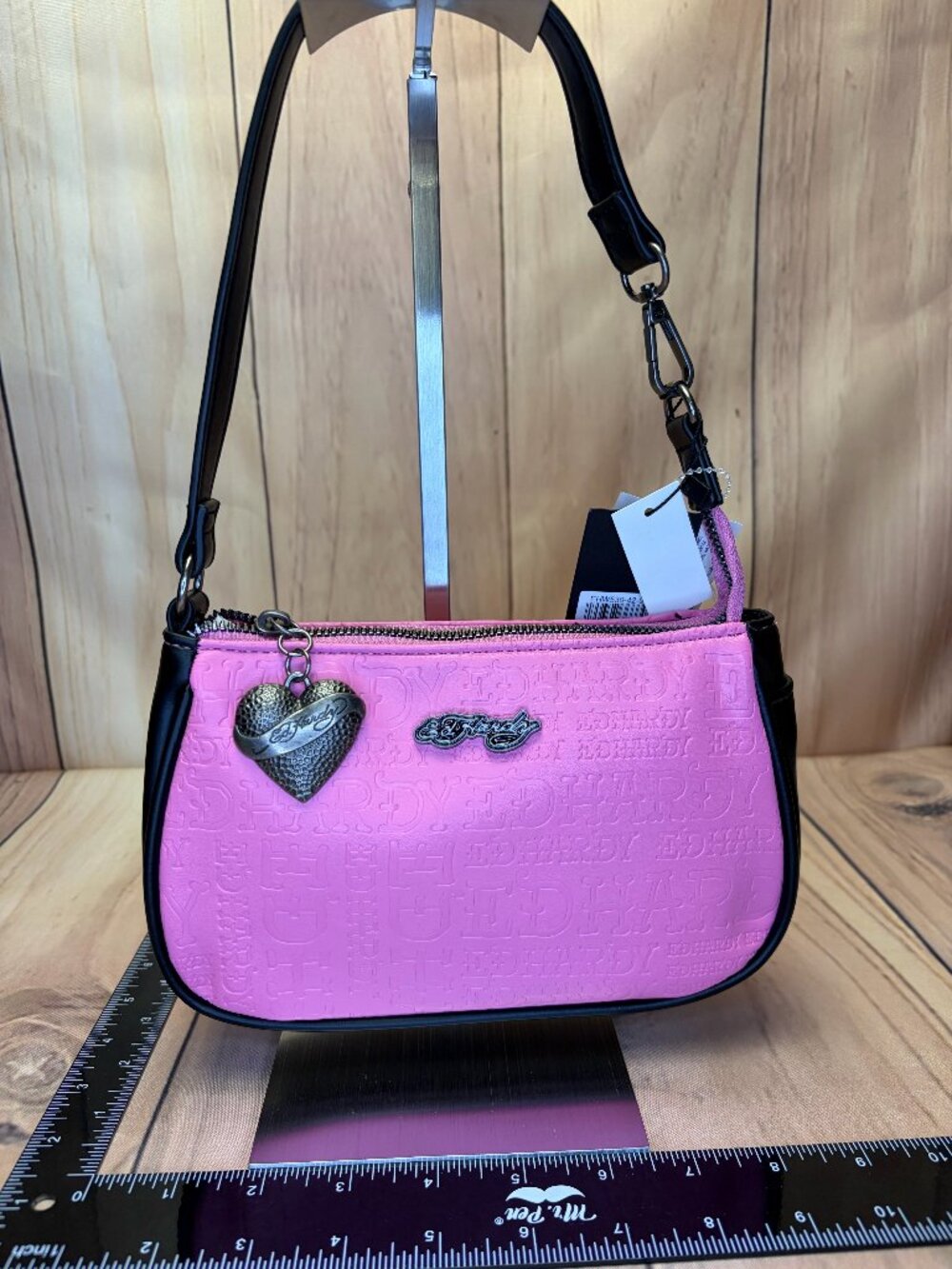 Ed Hardy pink shoulder bag featuring an embossed all-over logo design